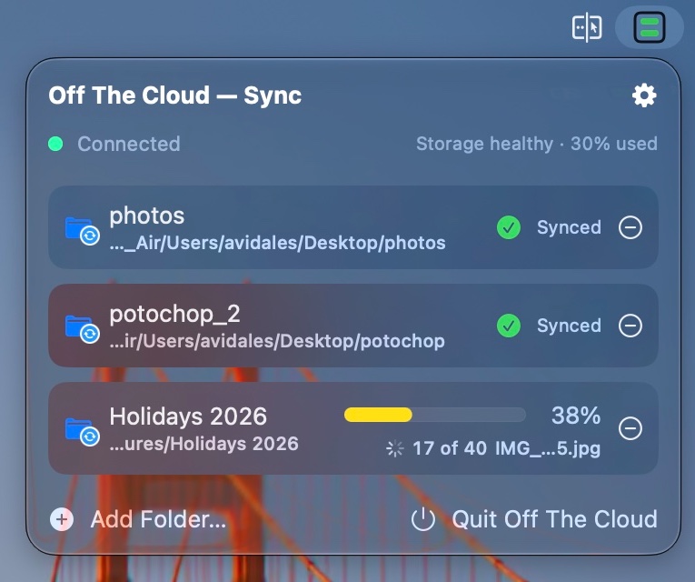 The Mac menu bar app: connected, storage healthy, two folders synced and one uploading